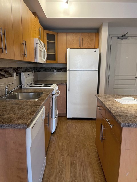 a kitchen with wooden cabinets and a white refrigerator